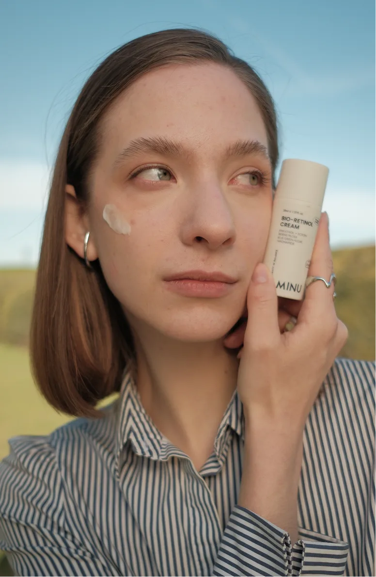 Aminu skincare campaign — model applying Aminu cream